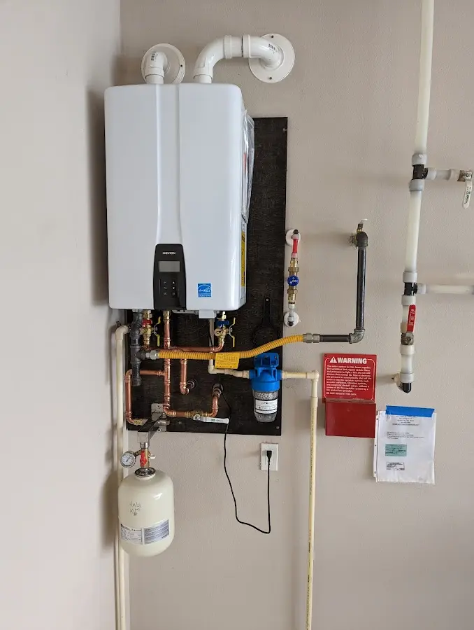 Professional plumber installing copper piping in a Plainwell home